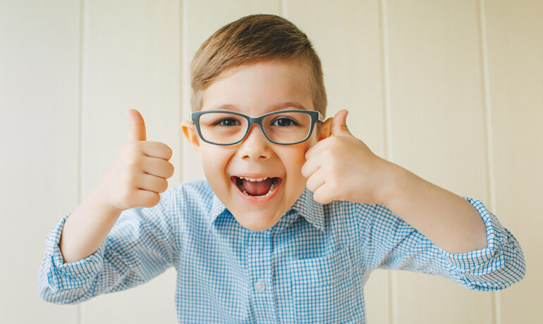 Young child wearing eyeglasses to correct vision, by RSF Optometry