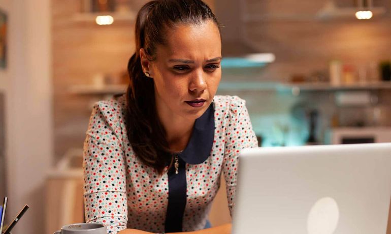 Woman with Correctable Vision Problem using laptop at table